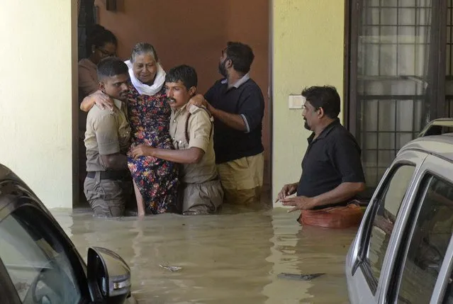 Firefighters rescue an elderly woman from a flooded apartment after heavy rainfall in Bangalore, India, Monday, September 5, 2022. Life for many in the southern Indian city of Bengaluru was disrupted on Tuesday after two days of torrential rains set off long traffic snarls, widespread power cuts and heavy floods that swept into homes and submerged roads. (Photo by Kashif Masood/AP Photo)