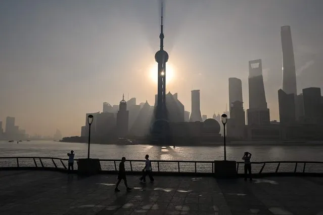 View of the financial district of Lujiazui during sunrise in Shanghai on September 7, 2022. (Photo by Hector Retamal/AFP Photo)