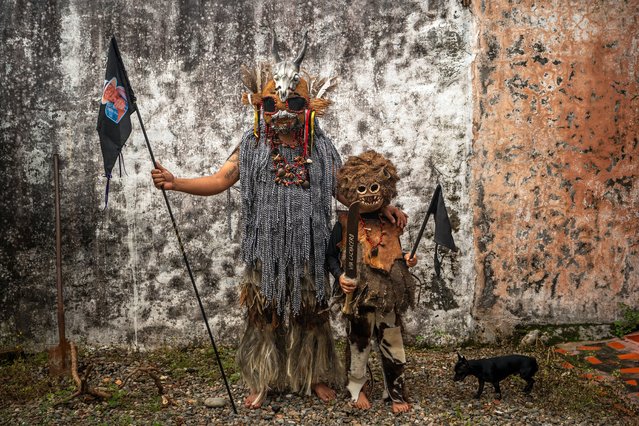 Alberto Alza, Cachacero, poses for a picture with his son as part of the 56th Folkloric and Tourist International Festival of the “llano” on November 11, 2023 in San Martin, Colombia. Positions as “Cachaceros” are respected according to their lineage, only the children of cuadrilleros can participate in the cuadrillas. the 'Cuadrillas de San Martin' is a tradition with almost 300 years old where the horsemen in San Martin show their skills in a contest with a series of 10 different games. It is not clear if the tradition comes from Spanish riders or from the Achagua indigenous, but the reason of the games was for fighting the territory between the Galanes, Moros, Guahibos and Cachaceros cultures, representing (in the same order) the Spanish, Arabs, indigenous and Africans. Today, is one of the most recognized cultural expression around and abroad Colombia. (Photo by Diego Cuevas/Getty Images)