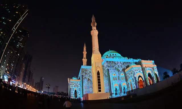 Al-Noor Mosque is lit up in a colourful display for the 10th annual Sharjah Light Festival in the Emirate of Sharjah, on February 7, 2020. (Photo by Giuseppe Cacace/AFP Photo)