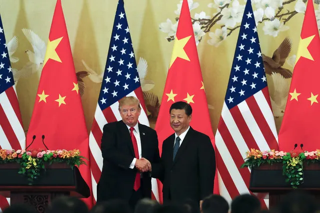 U.S. President Donald Trump, left, poses with Chinese President Xi Jinping for a photo after a joint press conference at the Great Hall of the People in Beijing, Thursday, November 9, 2017. Trump is on a five-country trip through Asia traveling to Japan, South Korea, China, Vietnam and the Philippines. (Photo by Andy Wong/AP Photo)
