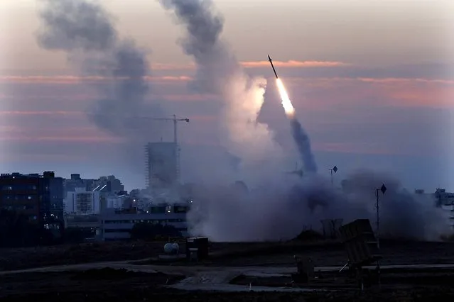 The Iron Dome defense system fires to interecept incoming missiles from Gaza in the port town of Ashdod, Israel on Thursday. (Photo by Tsafrir Abayov/Associated Press)