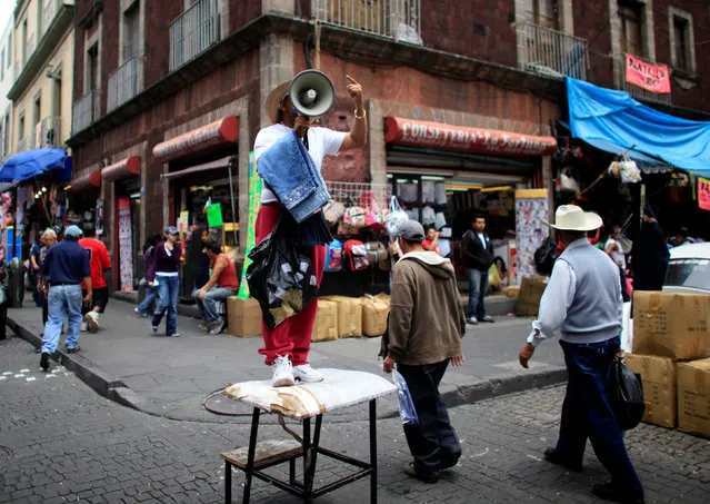 A man sells jeans in downtown Mexico City, Mexico August 23, 2010. (Photo by Eliana Aponte/Reuters)