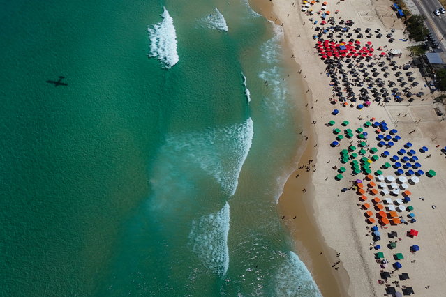 Aerial photo shows people enjoying the Barra da Tijuca beach in Rio de Janeiro, Brazil, 02 March 2025. (Photo by Antonio Lacerda/EPA)
