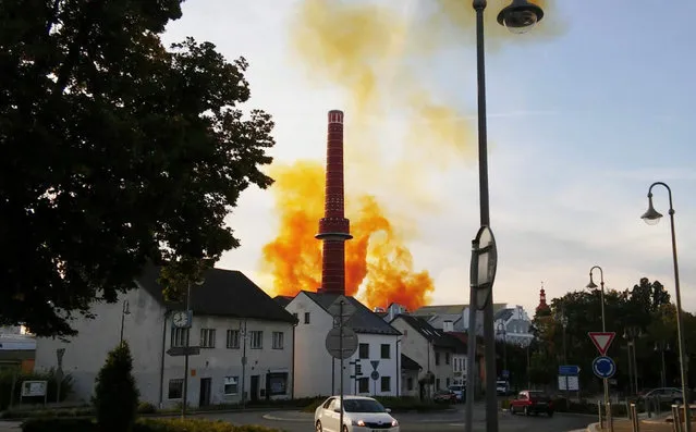 Orange smoke rises over a sugar distillery factory after an explosion in the town of Dobrovice, central Bohemia, Czech Republic, 22 September 2015. According to Czech media at least 14 people were injured, two of them seriously, in an explosion at the sugar factory and distillery. (Photo by Zdenek Kroupa/EPA)