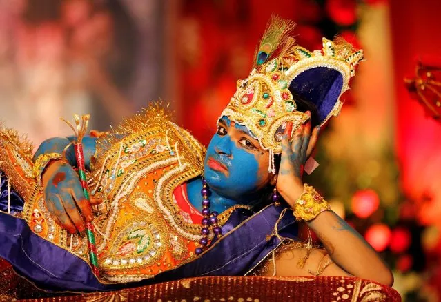 A girl dressed up as Hindu Lord Krishna performs during Janmashtami festival celebrations marking the birth of Lord Krishna, in Ahmedabad, India, August 25, 2016. (Photo by Amit Dave/Reuters)