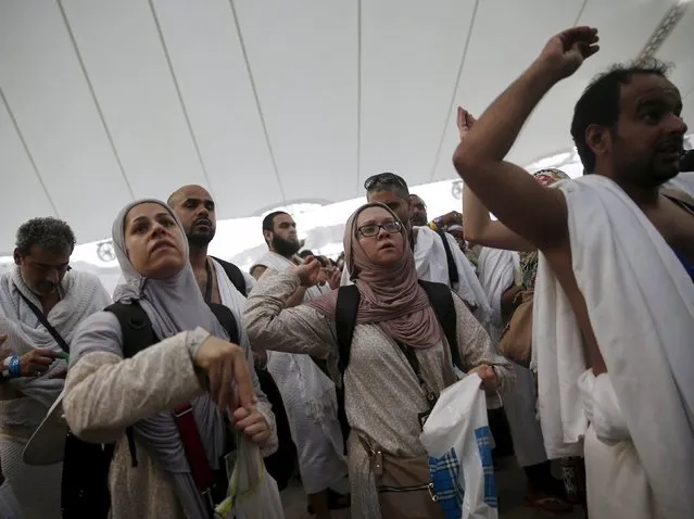 Muslim pilgrims cast stones at pillars symbolizing Satan, during the annual Haj pilgrimage on Eid al-Adha in Mina, near the holy city of Mecca September 24, 2015. (Photo by Ahmad Masood/Reuters)