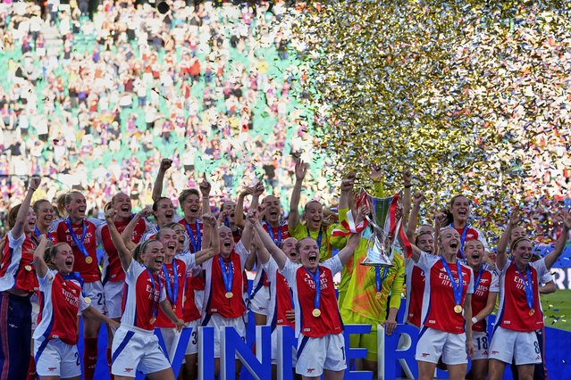 Arsenal players celebrate with their trophy after winning the women's Champions League final soccer match between Arsenal and FC Barcelona at the Jose Alvalade stadium in Lisbon, Saturday, May 24, 2025. (Photo by Armando Franca/AP Photo)