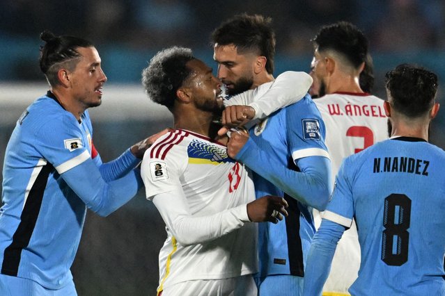 Venezuela's midfielder #13 Jose Martinez (2nd L) scuffles with Uruguay's midfielder #06 Rodrigo Bentancur during the 2026 FIFA World Cup South American qualifiers football match between Uruguay and Venezuela at the Centenario stadium in Montevideo on June 10, 2025. (Photo by Eitan Abramovich/AFP Photo)