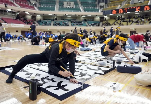Participants write with ink brushes during the New Year's first calligraphy contest at Nippon Budokan Hall in Tokyo, Japan, 05 January 2023. Around 1,800 people of all ages from across the nation participated in the annual event to display their Japanese calligraphic skills. (Photo by Franck Robichon/EPA/EFE/Rex Features/Shutterstock)