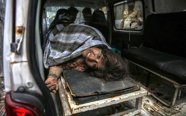 A survivor of a residential building's collapse lays in an ambulance in Bhiwandi, outskirts of Mumbai, India, 21 September 2020. According to reports, at least 10 people died and several are feared to be trapped under the rubble of the three-storey residential building. (Photo by Divyakant Solanki/EPA/EFE/Rex Features/Shutterstock)