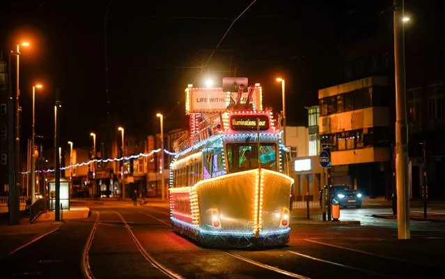 An illuminatyed vintage tram transits the promenade on October 06, 2020 in Blackpool, England. This year to help boost the tourism trade, which has been hit by the Covid-19 pandemic, Blackpool Illuminations will remain on display until January, two months longer than normal. (Photo by Christopher Furlong/Getty Images)