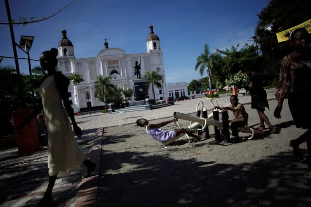 Kids play in a park next to Notre Dame cathedral in Cap Haitien, Haiti, September 18, 2016. (Photo by Andres Martinez Casares/Reuters)