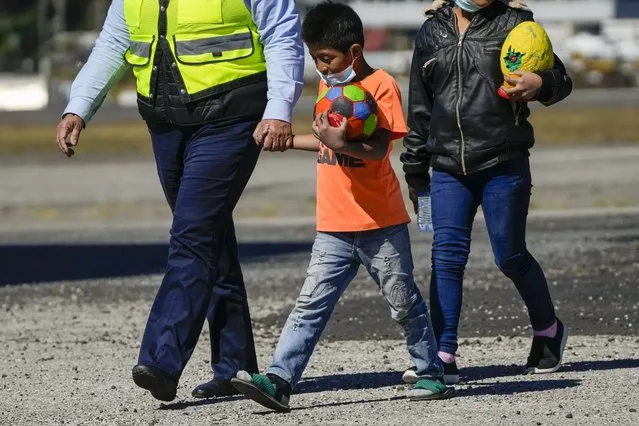 Two unaccompanied Guatemalan youths who were deported from Mexico deplane at La Aurora International Airport, along with other deported children, in Guatemala City, Tuesday, February 7, 2023. The children were stopped on the border between Mexico and United States. (Photo by Moises Castillo/AP Photo)