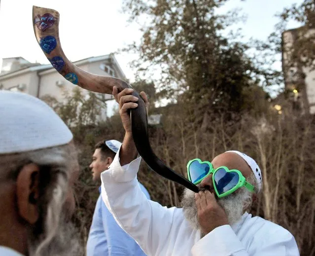 Hasidic Jews in the town of Uman celebrate Rosh Hashanah, the Jewish New Year, October 3, 2016, by blowing the shofar. (Photo by Viktor Drachev/TASS/Newscom)