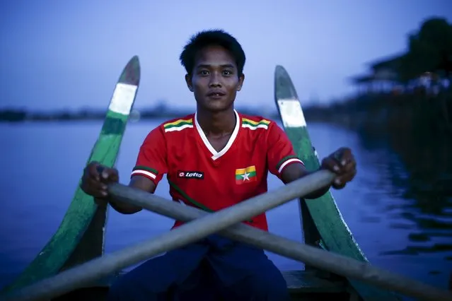 A youth wears a Myanmar national soccer team T-shirt while rowing a boat on Tuangthaman Lake in Mandalay October 6, 2015. (Photo by Jorge Silva/Reuters)