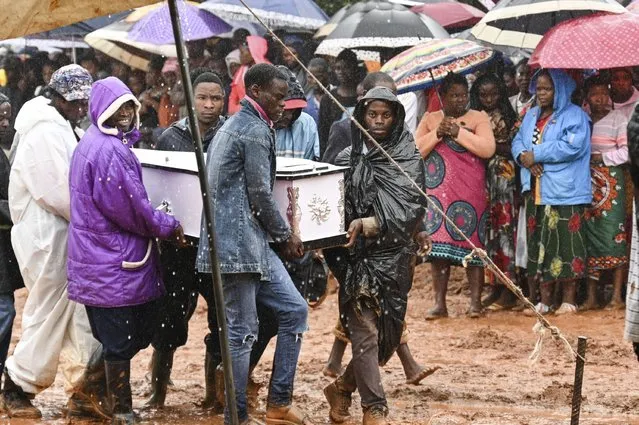 Pallbearers carry a coffin at the burial ceremony for some of the people who lost their lives following heavy rains caused by Cyclone Freddy in Blantyre, southern Malawi, Wednesday, March 15, 2023. After barreling through Mozambique and Malawi since late last week and killing hundreds and displacing thousands more, the cyclone is set to move away from land bringing some relief to regions who have been ravaged by torrential rain and powerful winds. (Photo by Thoko Chikondi/AP Photo)
