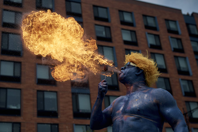 A performer spits fire during the Mermaid Parade in the Coney Island section of the Brooklyn borough of New York, Saturday, June 22, 2024. (Photob by Andres Kudacki/AP Photo)
