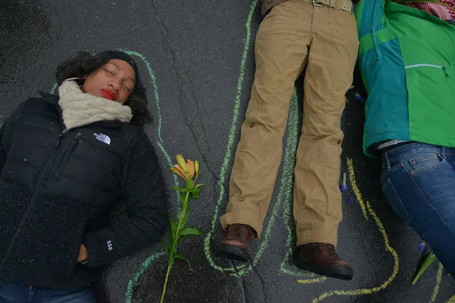 Organized by a group called TribeX, demonstrators perform a “Die In” where a police shooting of civilians is acted out on Sunday, November 16, 2014, in St. Louis, MO. The St. Louis suburbs are bracing for the outcome of the grand jury decision about whether or not to indict Ferguson police officer Darren Wilson in the shooting death of unarmed, African-American teenager Michael Brown. Many are hoping to avoid a repeat of the violence that broke out in the weeks following the shooting. (Photo by Jahi Chikwendiu/The Washington Post)