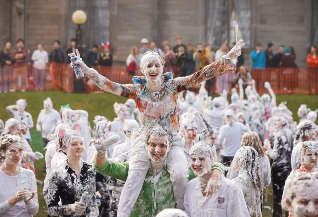 Students take part in the traditional Raisin Monday foam fight on St Salvator's Lower College Lawn at the University of St Andrews in Fife, UK on Monday, October 20, 2025. The messy display is the culmination of a weekend of festivities where first years say thank you to their more senior student “parents” for mentoring them. (Photo by Murdo MacLeod/The Guardian)