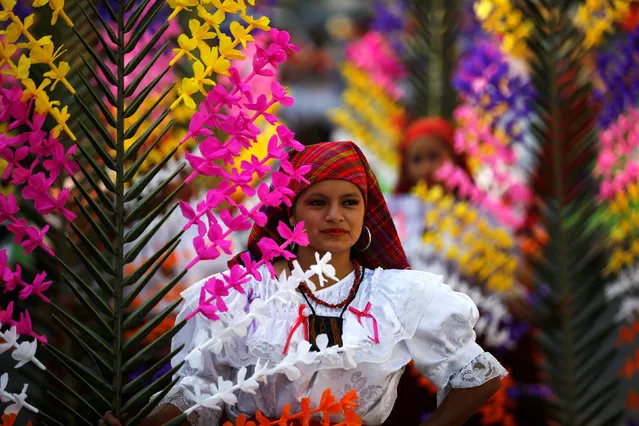 A girl dressed in traditional costumes takes part in the festivity of the Holy Cross to ask for a good rainy season in Panchimalco, El Salvador on May 3, 2018. (Photo by Jose Cabezas/Reuters)
