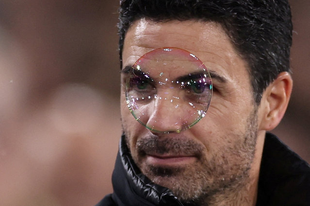 A bubble passes in front of the Arsenal manager, Mikel Arteta, prior to the Premier League match against West Ham at the London Stadium on November 30, 2024. (Photo by Hannah McKay/Reuters)