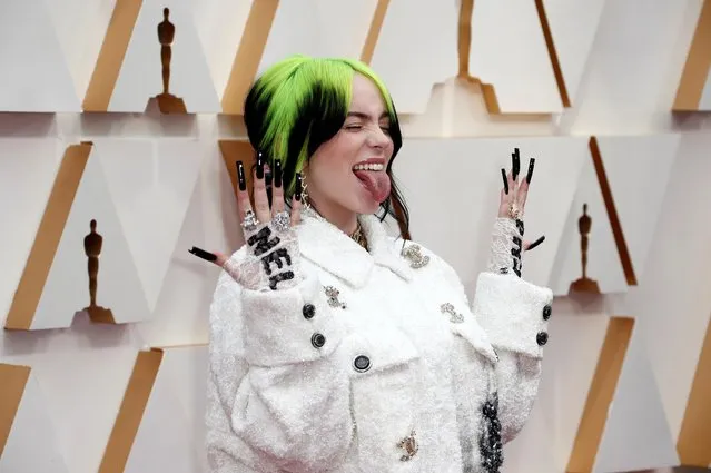 Billie Eilish in Chanel reacts as she poses on the red carpet during the Oscars arrivals at the 92nd Academy Awards in Hollywood, Los Angeles, California, U.S., February 9, 2020. (Photo by Eric Gaillard/Reuters)