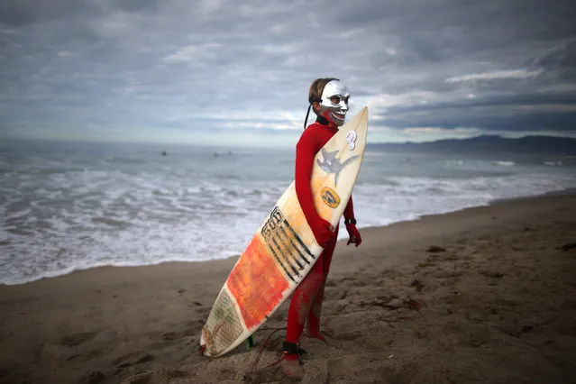 Beau Werger, 12, prepares to compete in the Haunted Heats Halloween Surf Contest in Santa Monica, California, U.S., October 29, 2016. (Photo by Lucy Nicholson/Reuters)