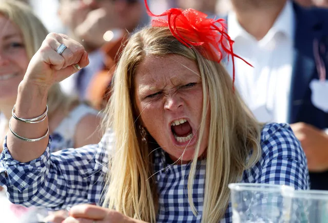 Racegoer cheer on horses during the Investec Ladies Day at Epsom Downs on June 1, 2018 in Epsom, England. (Photo by Peter Nicholls/Reuters)