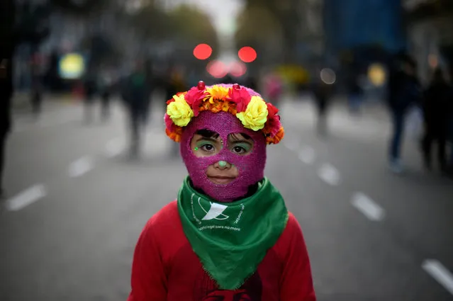 A little girl takes part in a march called by the movement “Ni una menos” (Not One Less) against violence against women, and in demand of the right to a safe, free and legal abortion in Buenos Aires, on June 04, 2018. (Photo by Eitan Abramovich/AFP Photo)