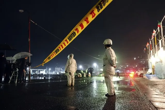 Police officers stand by a yellow rope restricting entry into the site at the Saikazaki port where a man threw an explosive just before Prime Minister Fumio Kishida was to make a campaign speech for a local governing party candidate Saturday, April 15, 2023, in Wakayama, western Japan. (Photo by Mari Yamaguchi/AP Photo)