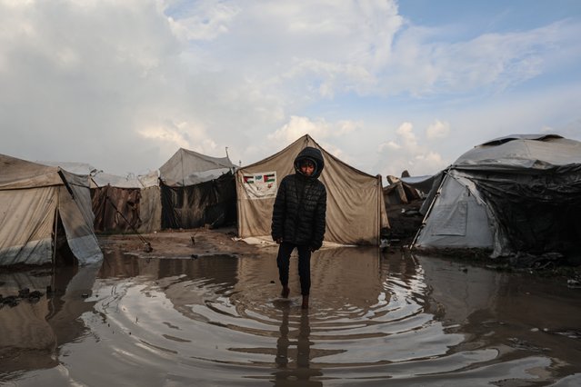 Palestinians struggle with flooding after heavy rain hits the Bureij Refugee Camp in Gaza City, Gaza on December 11, 2025. Conditions for displaced residents whose homes were destroyed in Israeli attacks, worsening as they continue to struggle not only with the devastation of the conflict but also with the deteriorating weather conditions. (Photo by Moiz Salhi/Anadolu via Getty Images)