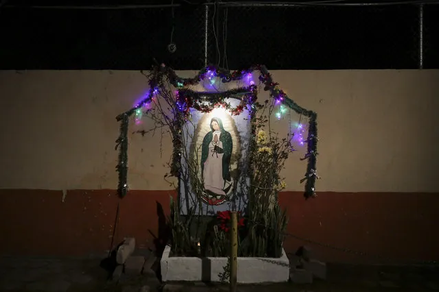 A neighborhood shrine to the Virgin of Guadalupe built in a wall is seen in Mexico City, Friday December 11, 2020. Nationwide, devotees of the Virgin make a pilgrimage to the Basilica in honor of her December 12 feast day, but the Catholic Church announced the closure of the Basilica for this year's pilgrimage due to the coronavirus pandemic. (Photo by Eduardo Verdugo/AP Photo)