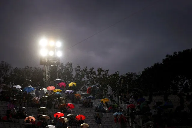 Spectators sit underneath umbrellas as a rain delay is announced in the men's singles semi-final match between Stefanos Tsitsipas of Greece and Daniil Medvedev during day thirteen of the Internazionali BNL D'Italia at Foro Italico on May 20, 2023 in Rome, Italy. (Photo by Alex Pantling/Getty Images)