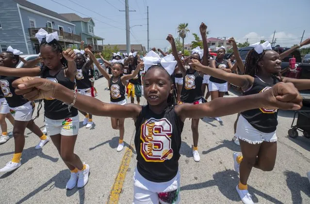 Chrisyah Riddeaux, center, marches along with her fellow cheerleaders in the annual Galveston Juneteenth Parade in Galveston, Texas, on Saturday, June 17, 2023. (Photo by Stuart Villanueva/The Galveston County Daily News via AP Photo)