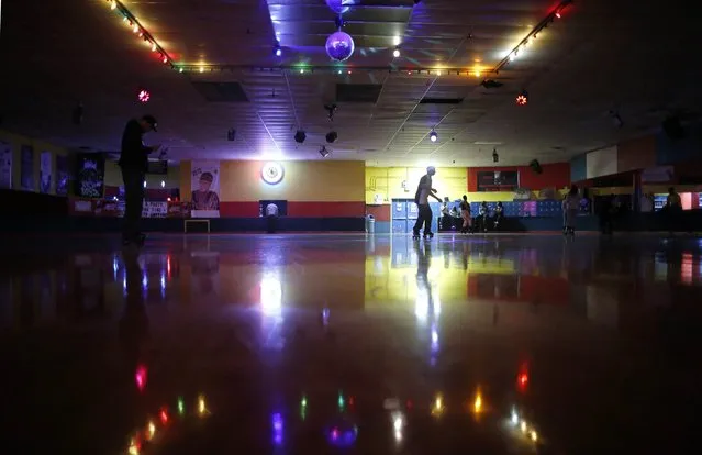 A man is reflected in the floor at “Rich City Skate” as he roller skates in Richton Park, Illinois, January 12, 2015. (Photo by Jim Young/Reuters)