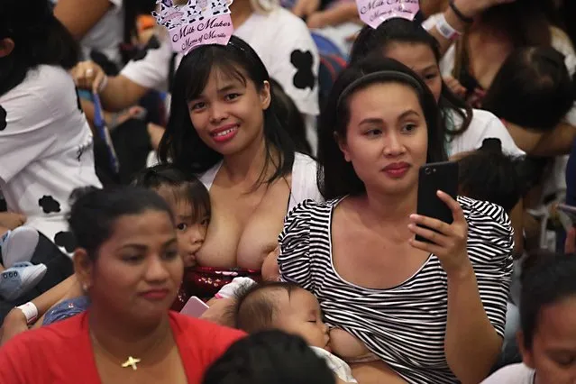 A mother takes a selfie while breastfeeding her baby at the “Hakab Na 2018”, an event held in celebration of National Breastfeeding Awareness Month at the SMX Convention Center in Pasay City, Philippines on Sunday, August 5, 2018. Now on its sixth year, the event is a gathering of families, lactation experts, peer counselors and breastfeeding advocacy supporters and was aimed at promoting the importance of providing support to breastfeeding mothers. (Photo by Avito C. Dalan/PNA Photo)