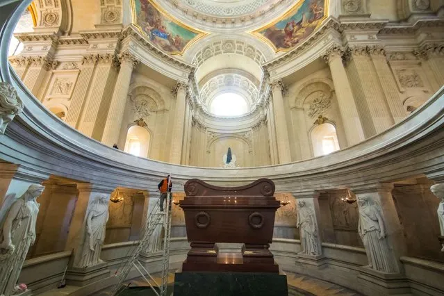 A worker cleans the tomb of Napoleon I during the final restoration works under the “Dome des Invalides” where his body lies under six separate sarcophagi at the Saint Louis des Invalides Cathedral in Paris, France, 16 April 2021. The French National Museum of the Invalides and the Napoleon Fondation financed the restoration as France prepares the celebrations of the bicentennial of the death of Napoleon Bonaparte, who died in exile on the island of Saint Helena on 05 May 1821. The official commemorations of his death is seen controversial in France among those considering Napoleon representing a dark part of the French history and those who support its legacy. (Photo by Christophe Petit Tesson/EPA/EFE)