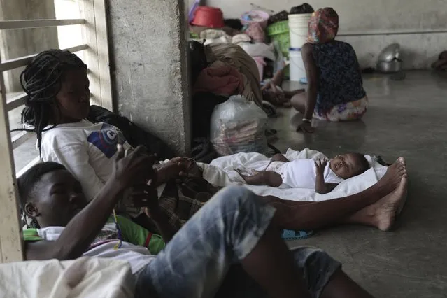 People displaced by the latest episode of gang violence take refuge at a school turned into a shelter, in the Carrefour-Feuilles neighborhood of Port-au-Prince, Haiti, Wednesday, August 16, 2023. Prime Minister Ariel Henry, who has led Haiti since the July 2021 assassination of President Jovenel Moïse, has been pushing for the deployment of a foreign armed force since October to help fight powerful gangs that control a large area of the capital of Port-au-Prince. (Photo by Joseph Odelyn/AP Photo)