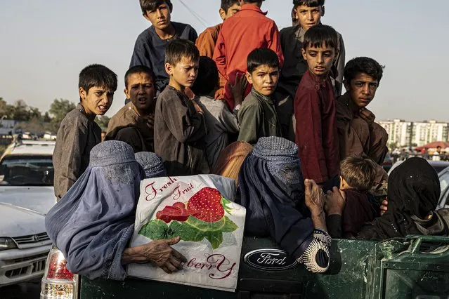 Afghan women and children are pictured on a military vehicle after being detained by the Taliban security personnel on charges of begging for alms, in Kabul on September 3, 2023. (Photo by Wakil Kohsar/AFP Photo)