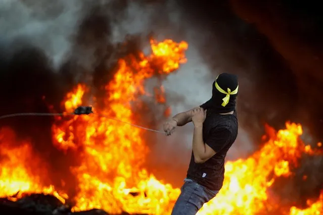 A Palestinian demonstrator takes part in an anti-Israel protest over a cross-border violence between Palestinian militants in Gaza and the Israeli military, near Hawara checkpoint near Nablus in the Israeli-occupied West Bank, May 18, 2021. (Photo by Raneen Sawafta/Reuters)