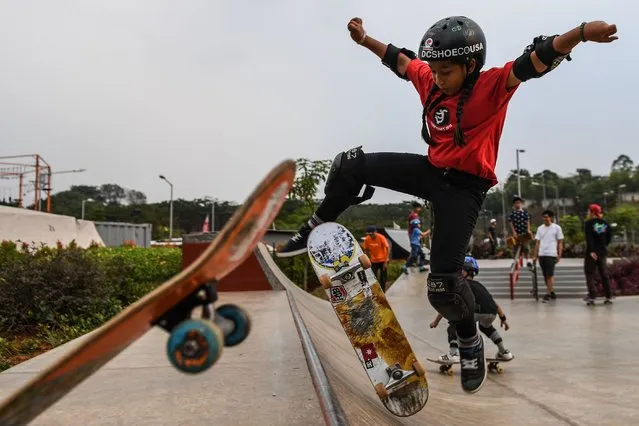 This picture taken on August 17, 2018 shows Indonesian skateboarder Aliqqa Noverry, 9, demonstrating her skills at a public park ahead of the 2018 Asian Games in Jakarta. The youngest competitor at this year's event in Jakarta, the pint-sized adrenaline junkie Noverry loves nothing better than to rip into jumps at breakneck speed, her pigtails billowing behind her. (Photo by Mohd Rasfan/AFP Photo)