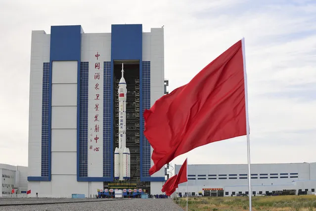 In this photo released by Xinhua News Agency, the Shenzhou-12 manned spaceship with its Long March-2F carrier rocket is being transferred to the launching area of Jiuquan Satellite Launch Center in northwestern China's Gansu province, on Wednesday, June 9, 2021. A three-man crew of astronauts will blast off in June for a three-month mission on China's new space station, according to a space official who was the country's first astronaut in orbit in May. (Photo by Wang Jiangbo/Xinhua via AP Photo)