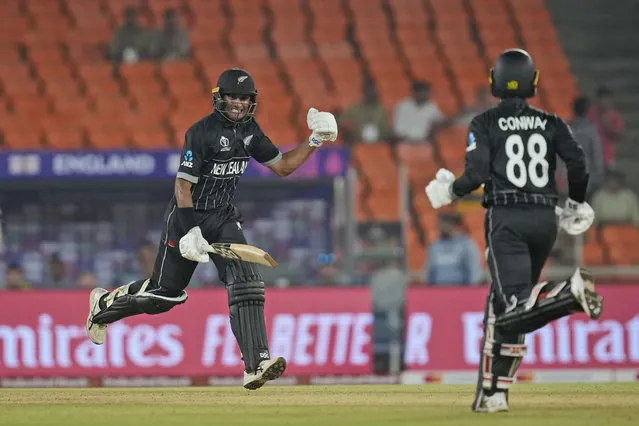 New Zealand's Rachin Ravindra and teammate Devon Conway complete the winning run during the ICC Cricket World Cup opening match between England and New Zealand in Ahmedabad, India, Thursday, October 5, 2023. (Photo by Rafiq Maqbool/AP Photo)