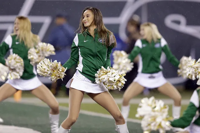 In this November 12, 2015 file photo, New York Jets cheerleaders perform during the first half of an NFL football game between the Jets and the Buffalo Bills in East Rutherford, N.J. The New York Jets have agreed to pay nearly $324,000 to settle a class-action lawsuit filed by cheerleaders who claimed that they were cheated out of wages and forced to cover work-related expenses. (Photo by Seth Wenig/AP Photo)