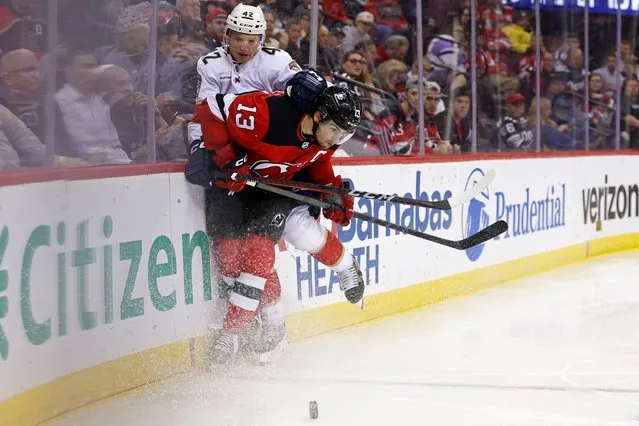 New Jersey Devils center Nico Hischier (13) checks Florida Panthers defenseman Gustav Forsling (42) in the second period of an NHL hockey game, Monday, October 16, 2023, in Newark, N.J. (Photo by Adam Hunger/AP Photo)