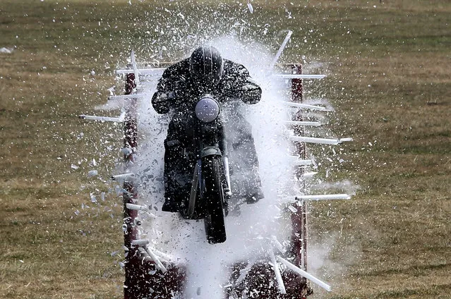 Members of Army Service Corps (ASC) motorcycle display team known as the “Tornadoes” display their biking skills, during the 258th Anniversary of Army Service Crops Center and College, in Bangalore, India, 09 December 2018. Indian Army Service Corps, established in 1760, is an arm of the Indian Army handling logistic support. (Photo by Jagadeesh N.V./EPA/EFE)