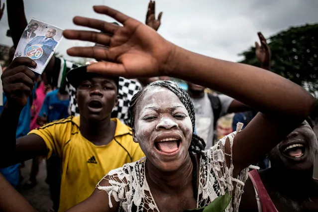 Supporters of the newly elected president of the Democratic republic of Congo, Felix Tshisekedi, celebrate in the streets of Kinshasa on January 10, 2019. The Democratic Republic of Congo's opposition leader Felix Tshisekedi was named on January 10 the provisional winner of a long-awaited presidential poll paving the way for the crisis-hit country's first transfer of power in 18 years. (Photo by John Wessels/AFP Photo)