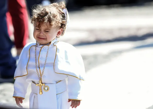 A child dressed as a Pope cries during the weekly Angelus prayer on March 3, 2019 at St. Peter's square in the Vatican. (Photo by Tiziana Fabi/AFP Photo)