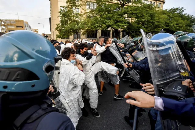 Clashes in Milan, Italy on September 30, 2021 between police and Extinction Rebellion activists who blocked traffic in front of the MiCo, the Milan Convention Center in the Fiera area, where PreCop 26 on climate change begins today. (Photo by Claudio Furlan/Zuma via AP Photo)